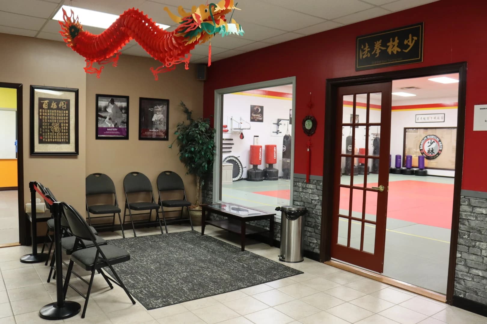 Parent viewing area with seating and a window into the training hall